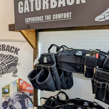 Display of Gatorback bags in a store setting with branded signage.